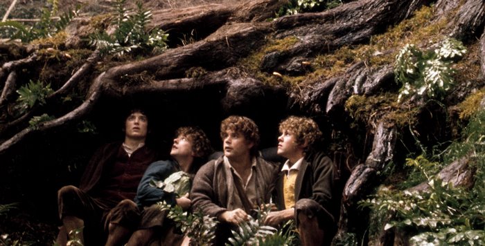 Four hobbits hiding under tree roots