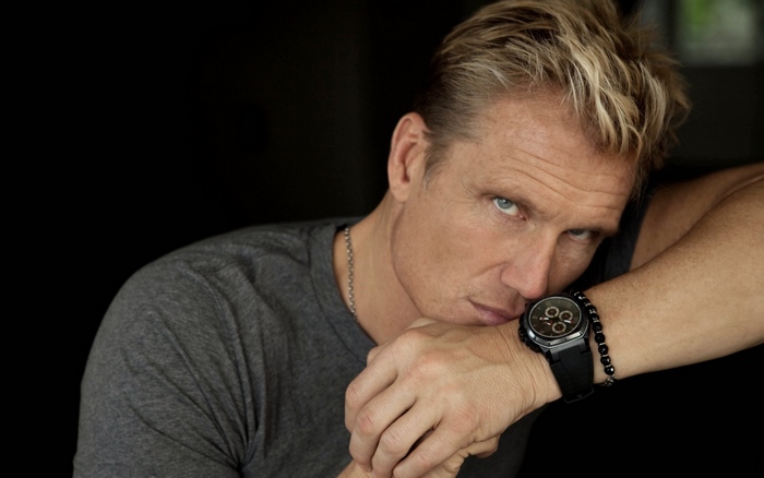 Dolph Lundgren wearing a grey t-shirt and watch