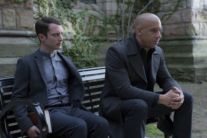 Elijah Wood and Vin Diesel sitting on a bench