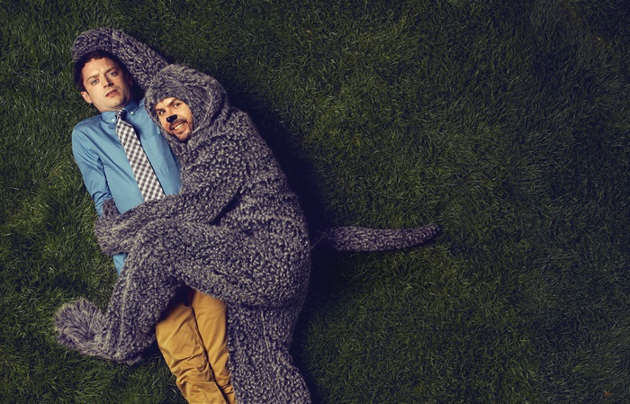 Elijah Wood in a wolf costume on grass