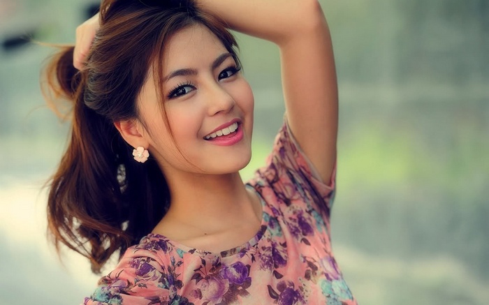 Young woman with hand in hair smiling