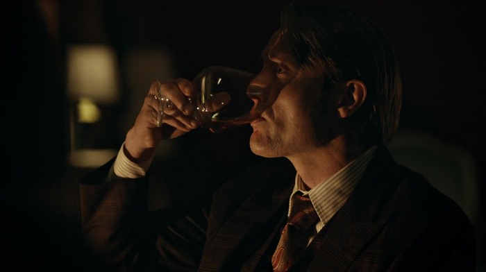 Mads Mikkelsen drinking red wine