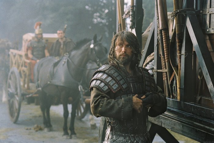 Mads Mikkelsen in armor with a cart and horses