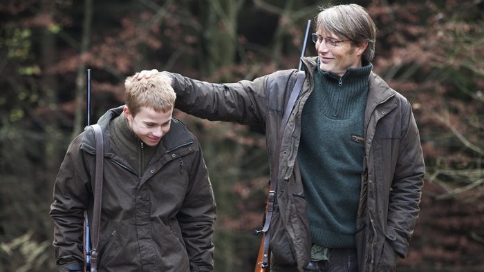 Mads Mikkelsen with a young boy in a forest