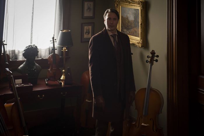 Mads Mikkelsen in a room with violins