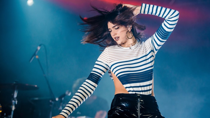 Dua Lipa Singing on Stage with Energetic Pose
