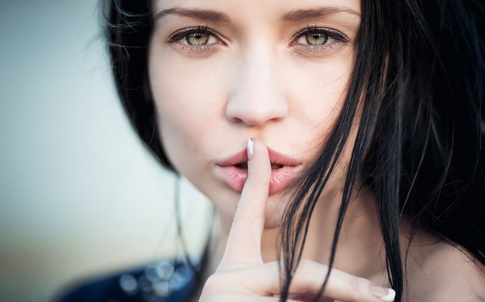 Woman with finger on lips