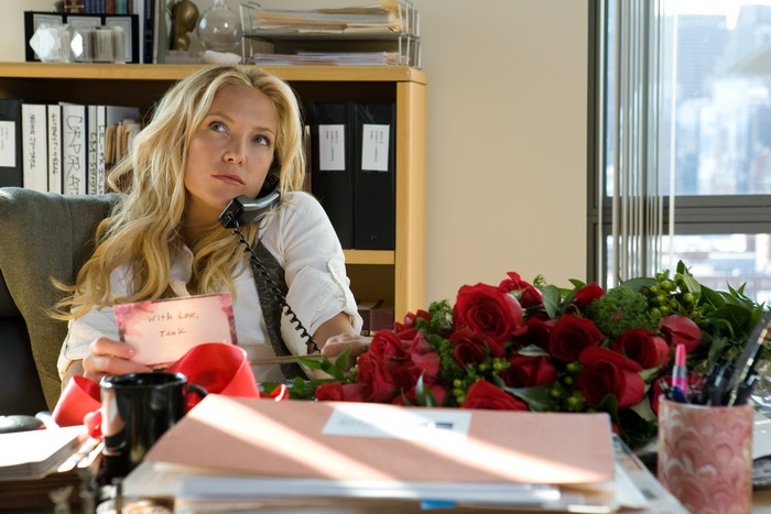 Kate Hudson on the phone with flowers