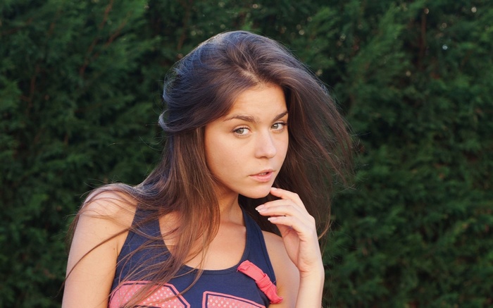 Young woman with long brown hair outdoors