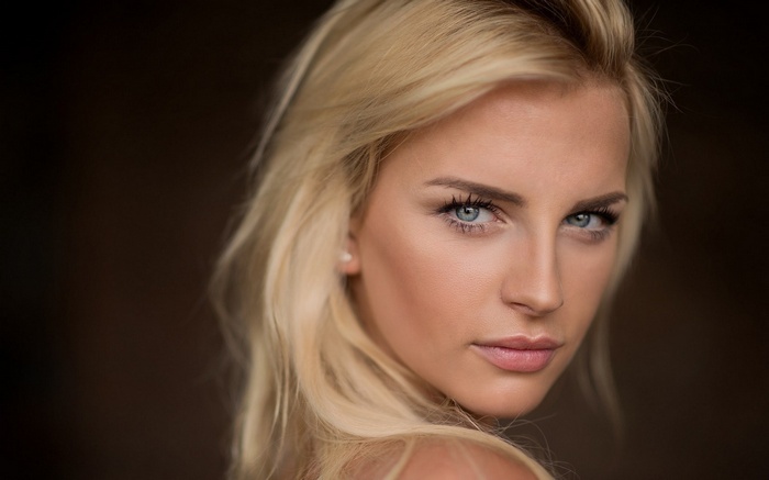 Close-up portrait of a blonde woman with blue eyes
