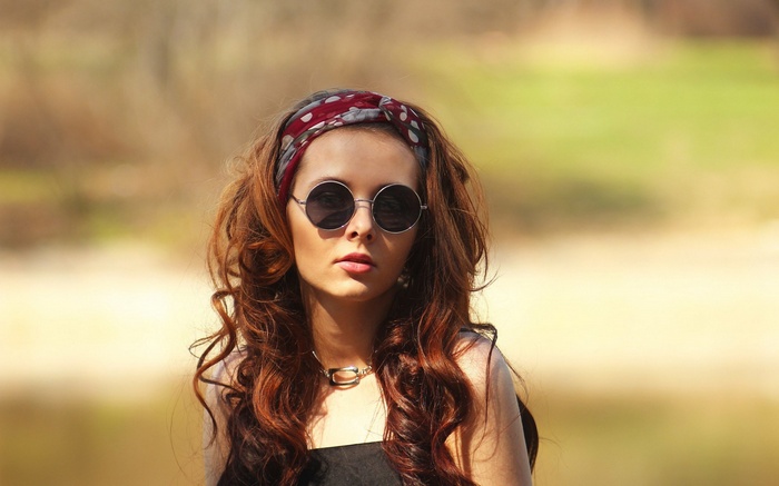 Woman with sunglasses and bandana