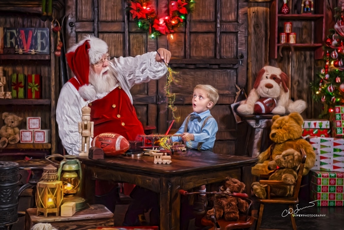Santa Claus with a young boy in his workshop