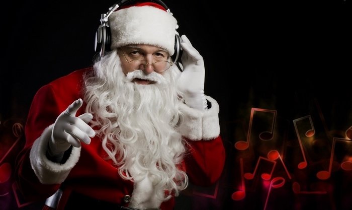 Santa Claus wearing headphones and pointing