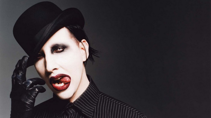 Marilyn Manson wearing a top hat and makeup