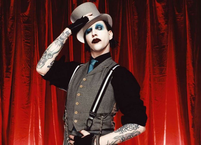 Marilyn Manson wearing a top hat and vest