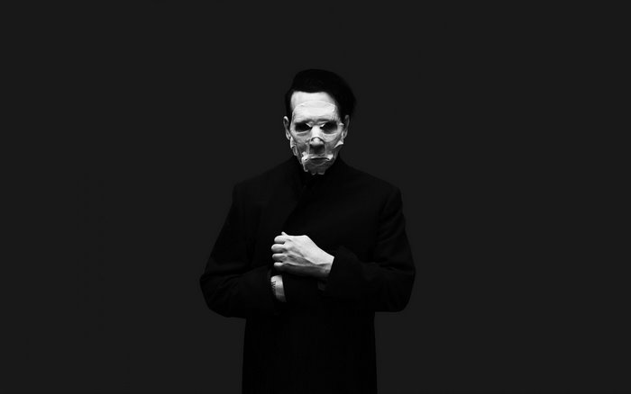 Marilyn Manson in a mask and coat