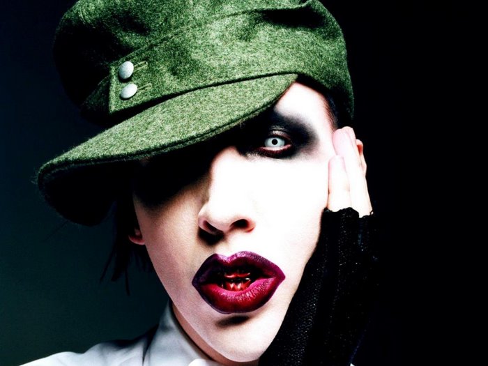 Marilyn Manson wearing a green cap