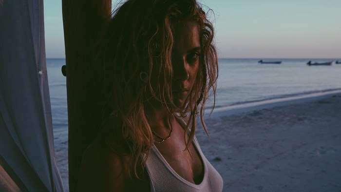 Ashley Benson on a beach at sunset