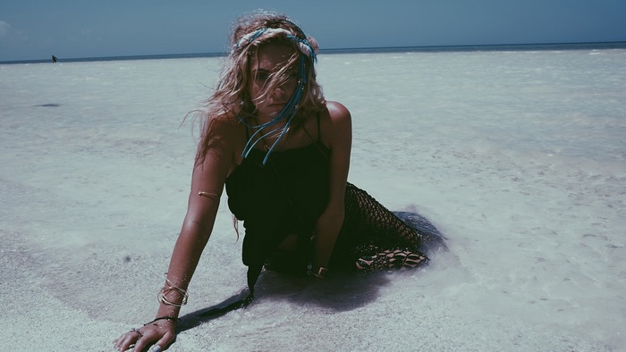 Ashley Benson on a shallow beach