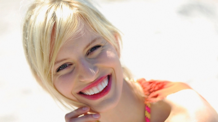 Karolina Kurkova smiling on a beach