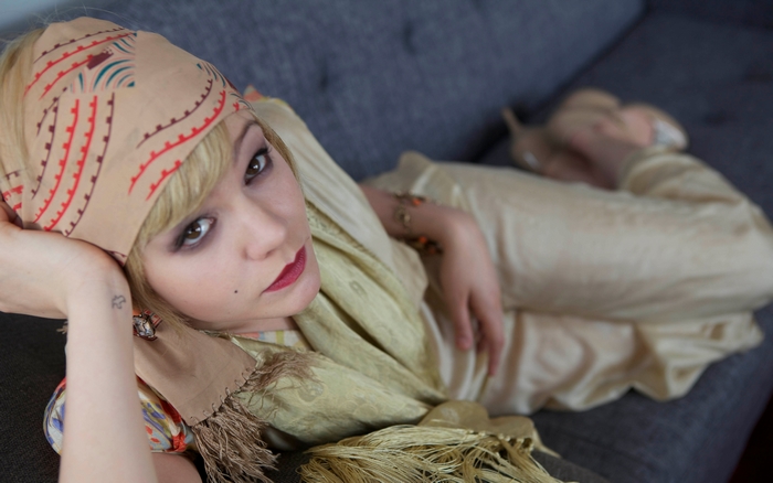 Carey Mulligan lying on a couch