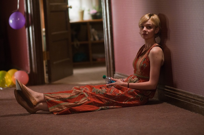 Carey Mulligan sitting on floor with balloons