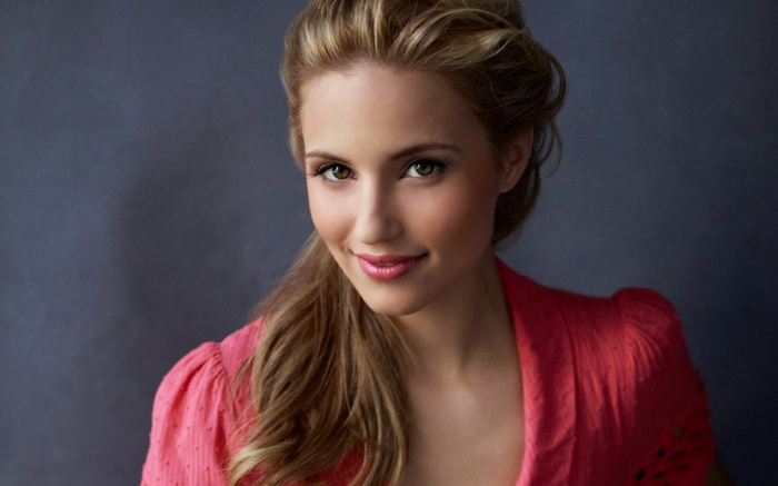 Woman with blonde hair wearing a pink jacket