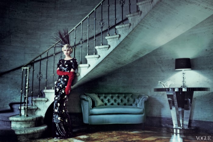 Carey Mulligan in a black floral dress and red gloves