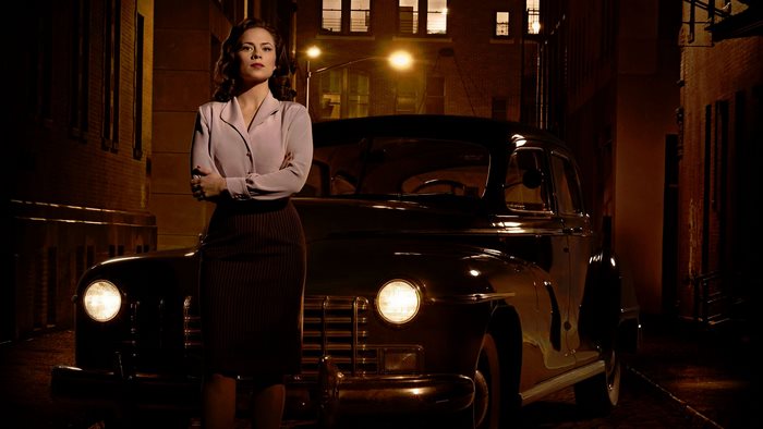 Peggy Carter in a vintage car at night