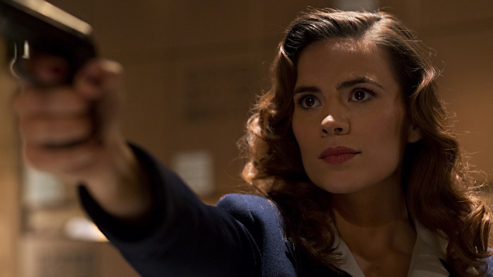 Peggy Carter from Marvel aiming a handgun