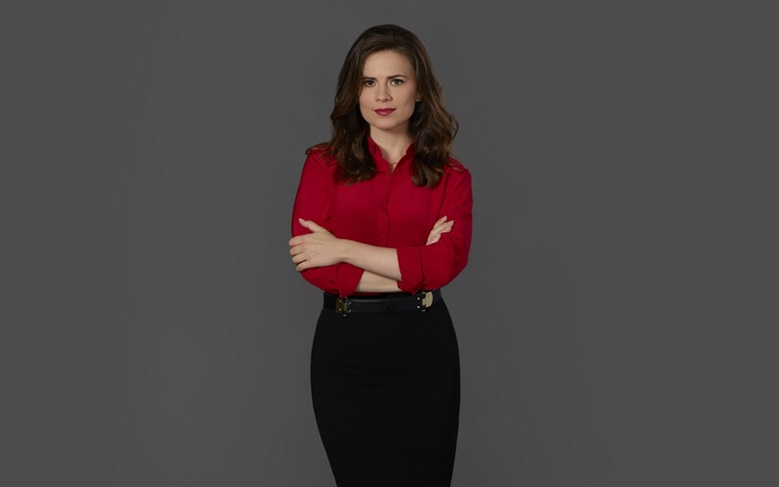Hayley Atwell in a red shirt and black skirt