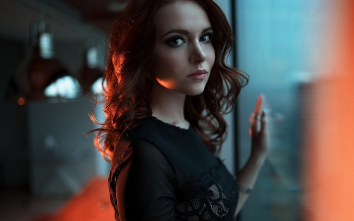 Woman with red hair in a black lace top