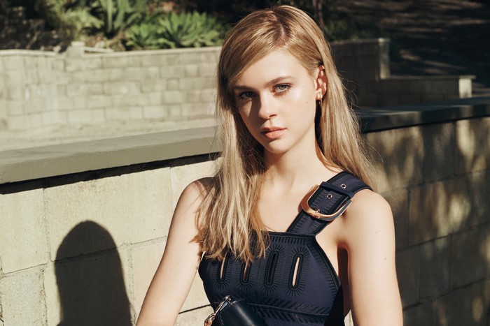Nicola Peltz in a dark blue dress