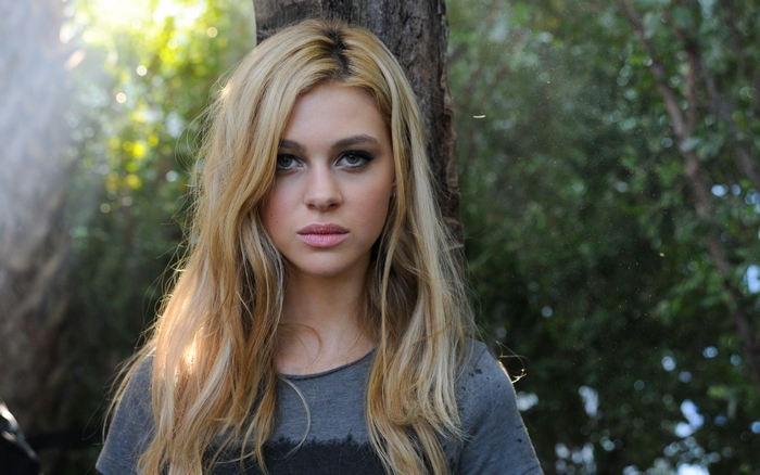 Nicola Peltz in a forest