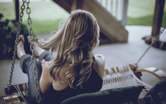 Woman on a porch swing