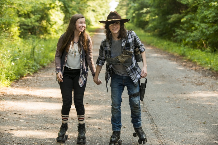 Carl Grimes and Enid from The Walking Dead on roller skates