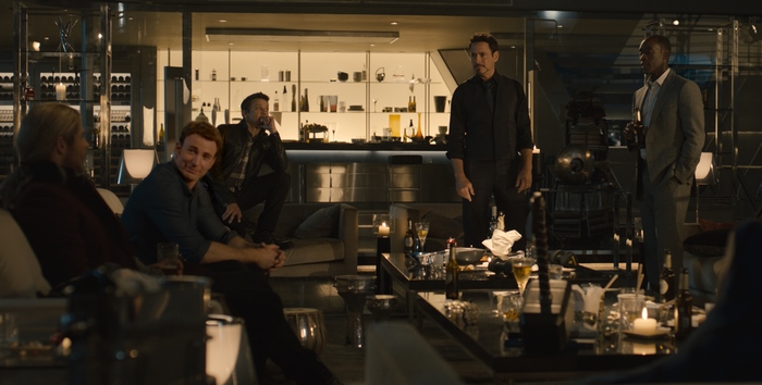 Don Cheadle and others in a modern lounge