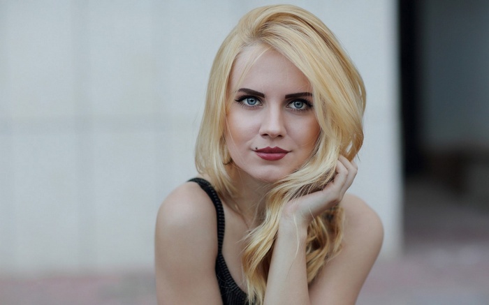 Blonde woman with blue eyes and mole