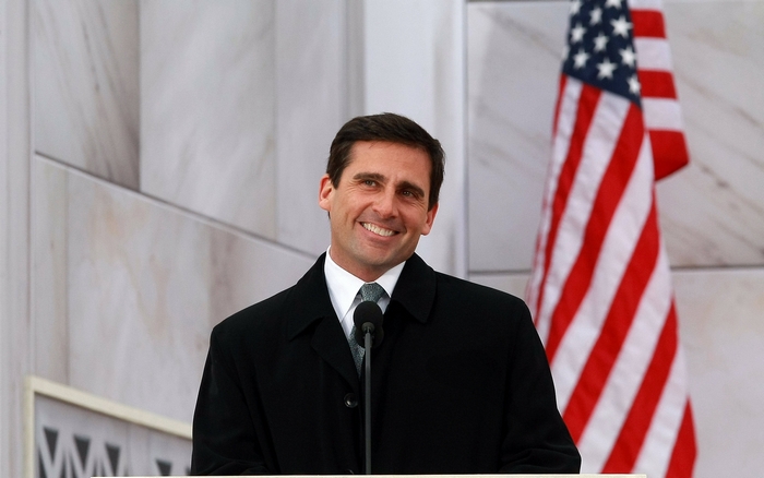 Steve Carell at a podium with American flag