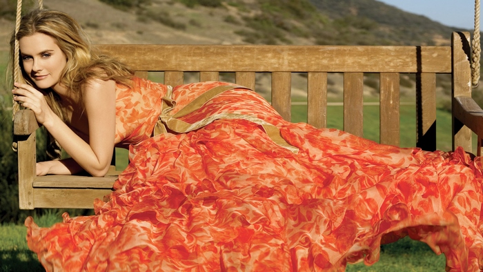 Alicia Silverstone on a wooden swing