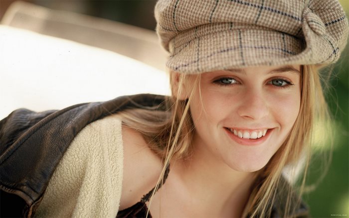 Alicia Silverstone wearing a plaid cap