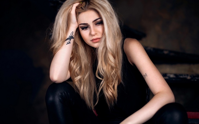 Woman with blonde hair and tattoos