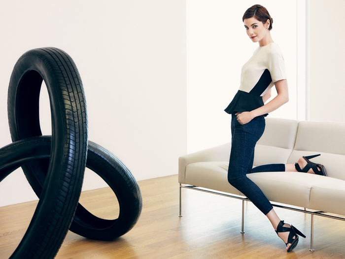 Michelle Monaghan posing on a couch with tires