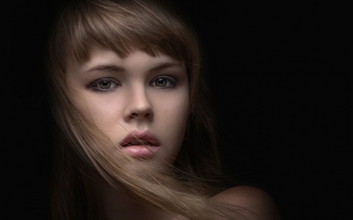 Woman with hair blowing across her face