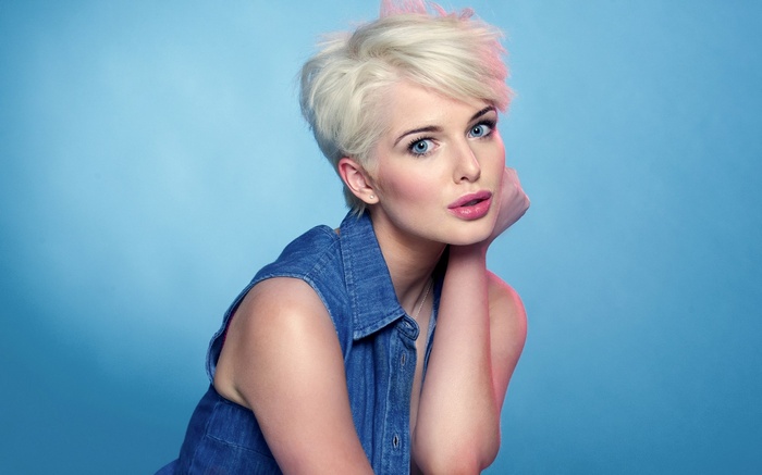 Woman with blonde pixie cut and denim shirt