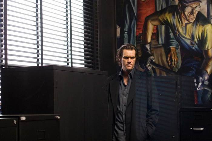 Jim Carrey in an office with a mural