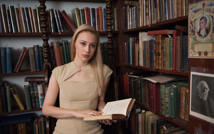 Sarah Gadon reading a book in a library
