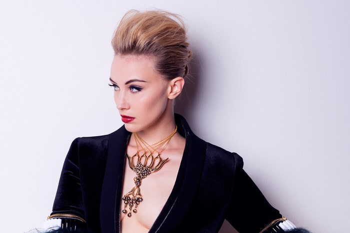 Sarah Gadon wearing a black jacket and necklace