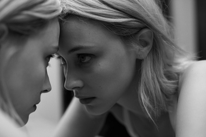 Sarah Gadon looking in a mirror