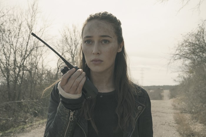 Alycia Debnam-Carey holding a walkie-talkie